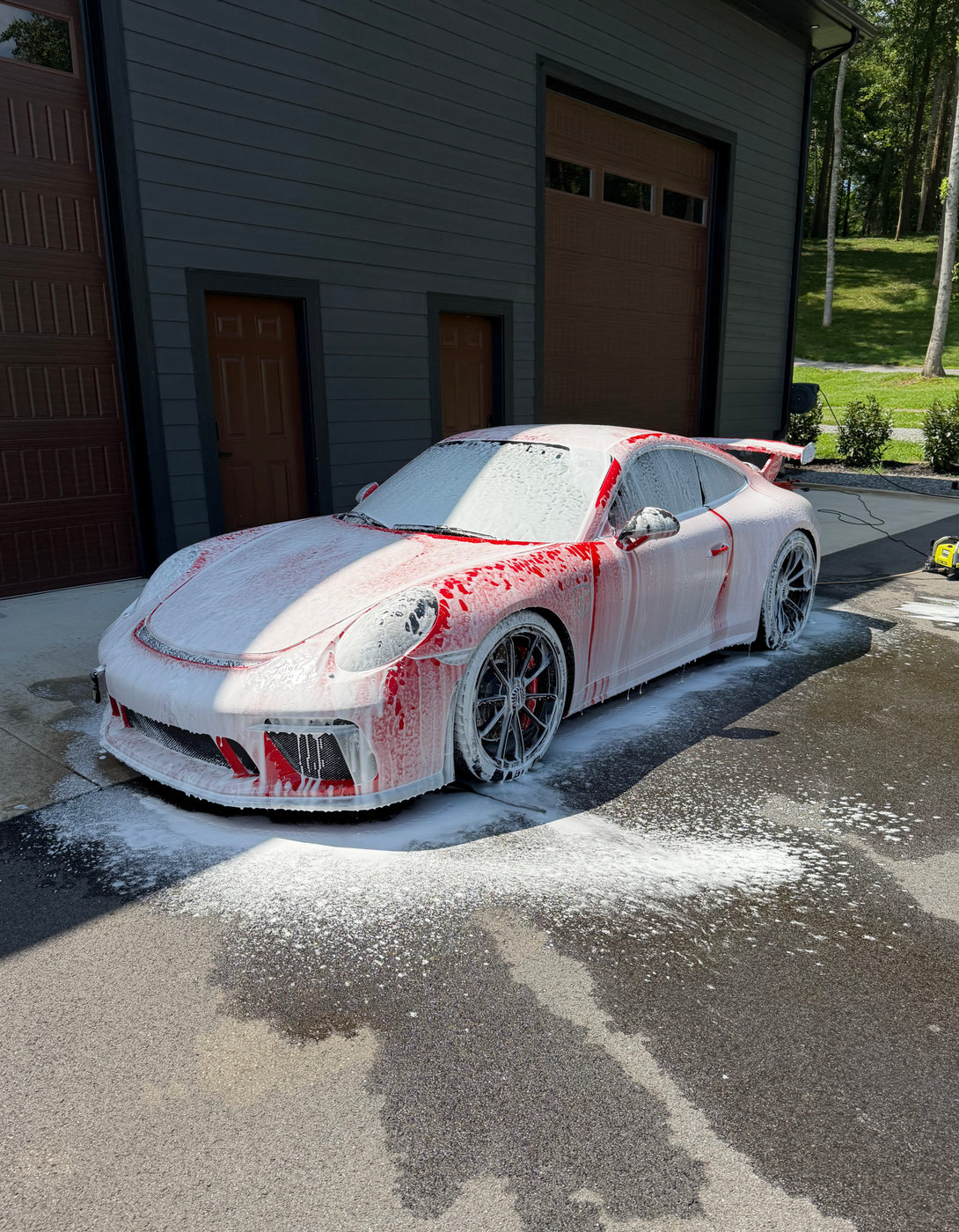 Porsche 911 GT3 covered in foam during a full detail